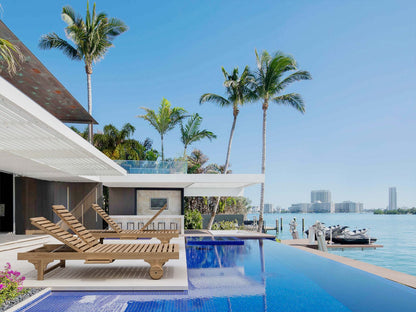 Luxury pool area with lounge chairs, palm trees, and waterfront view.