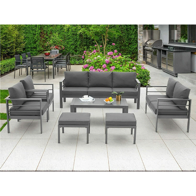 Outdoor patio furniture set with gray cushions on a tiled patio.