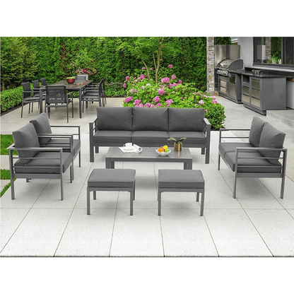 Outdoor patio furniture set with gray cushions on a tiled patio.