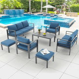 Outdoor patio furniture set with blue cushions by a pool