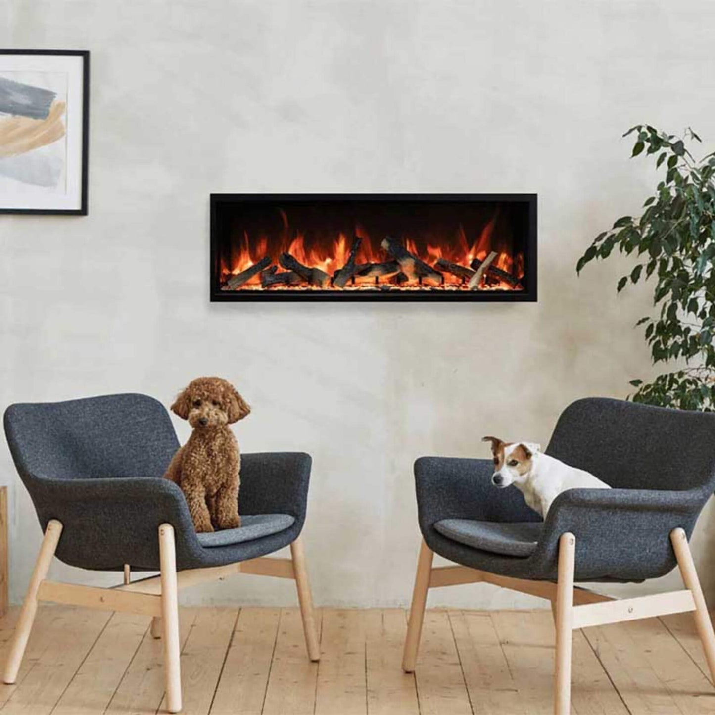 Two dogs sitting on gray chairs in front of a modern electric fireplace.