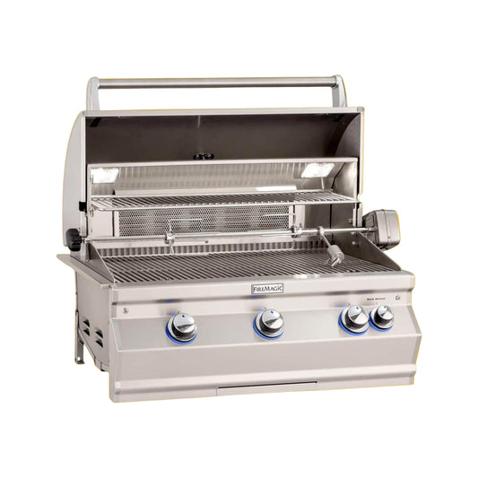 A built-in Fire Magic Aurora Multi-User Built-In Grill with analog thermometer and rotisserie kit, featuring stainless steel construction and blue control knobs, against an orange background.