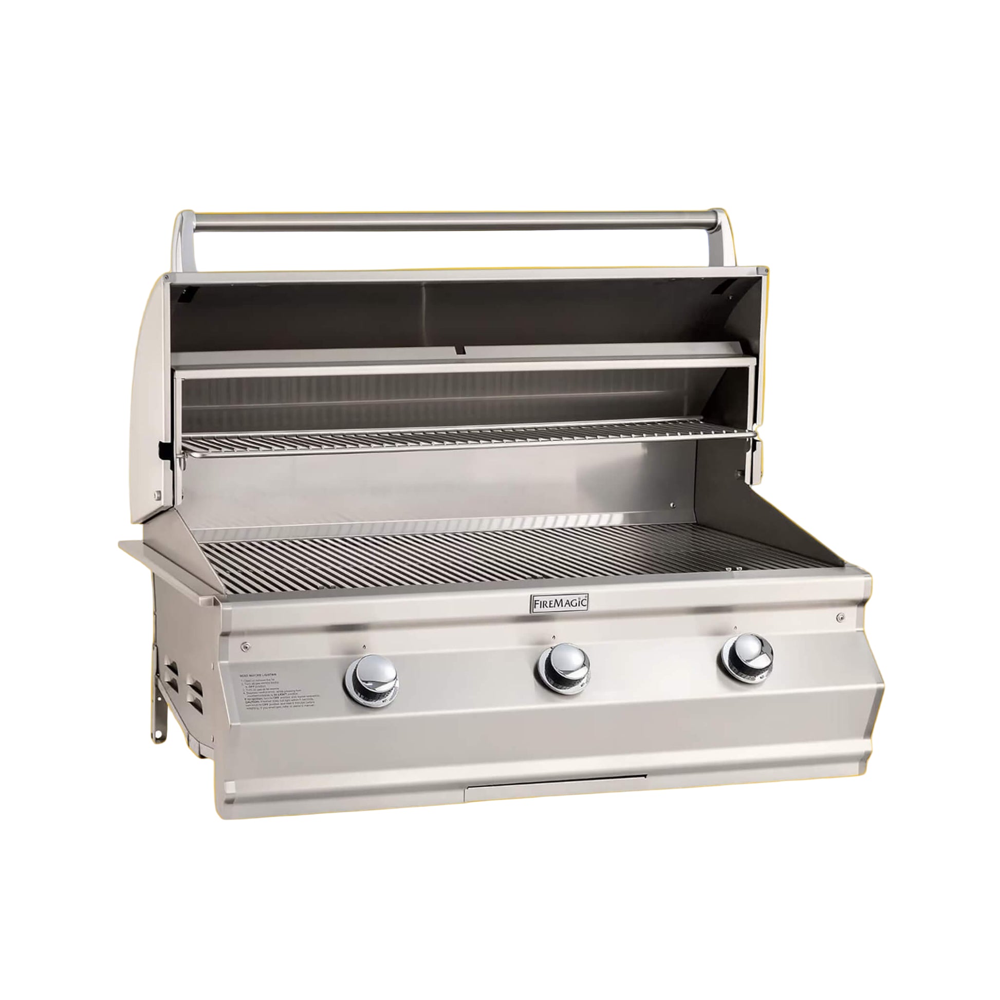 A built-in Fire Magic Choice Multi-User Grill with analog thermometer, featuring three control knobs and a stainless steel construction, displayed against an orange background.