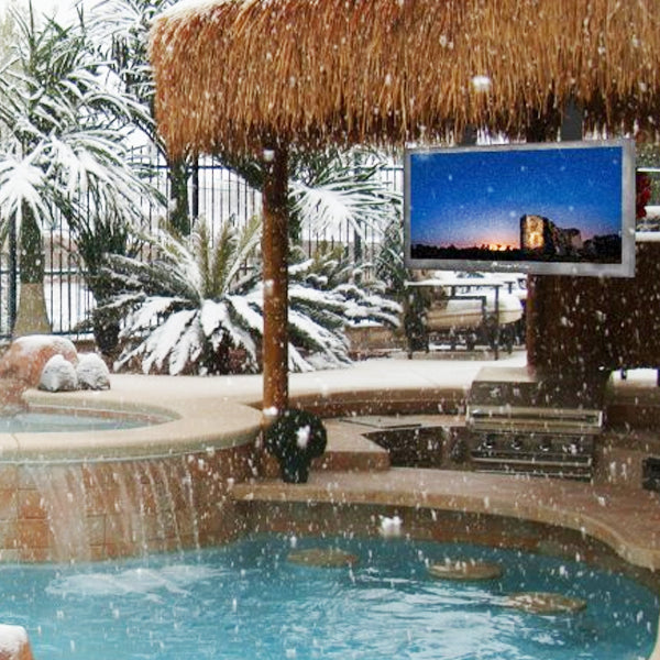 Outdoor patio with pool, thatched roof, and TV displaying a scenic view.