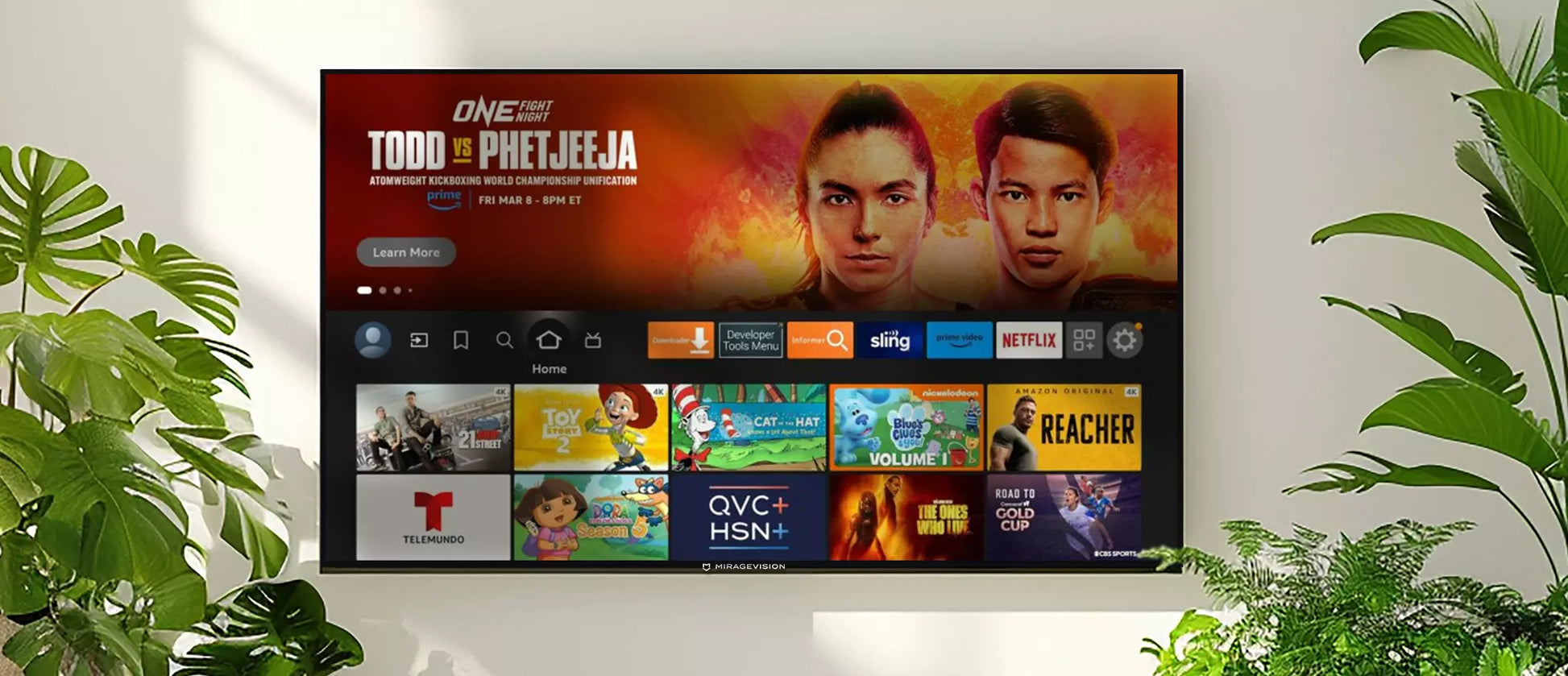 Smart MirageVision Outdoor TV displaying a streaming platform interface with various channels on a white wall background.