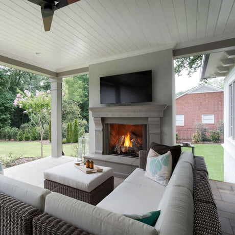 Outdoor patio with fireplace, TV, and comfortable seating area.