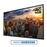 Samsung 4K Ultra HD television displaying a cityscape with 'Powered by Samsung' text.