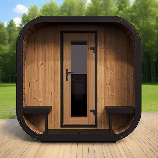 Wooden outdoor sauna with black trim on a wooden deck with greenery in the background