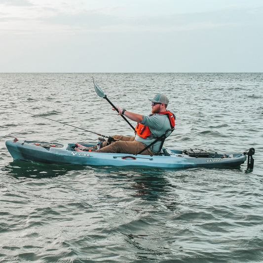 Vibe Sea Ghost 110 Fishing Kayak gliding on calm river waters
