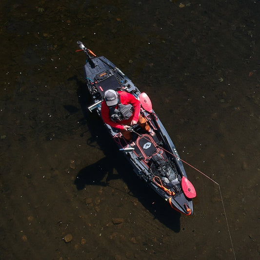 Angler fishing from Vibe Shearwater 125 kayak equipped with rod holders
