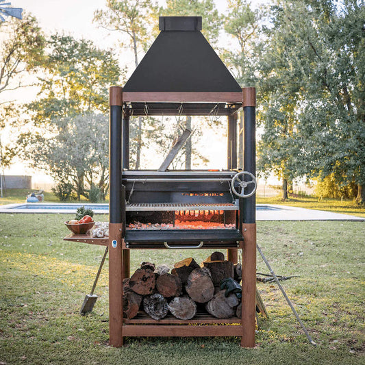 Outdoor barbecue grill with wood storage on a grassy area