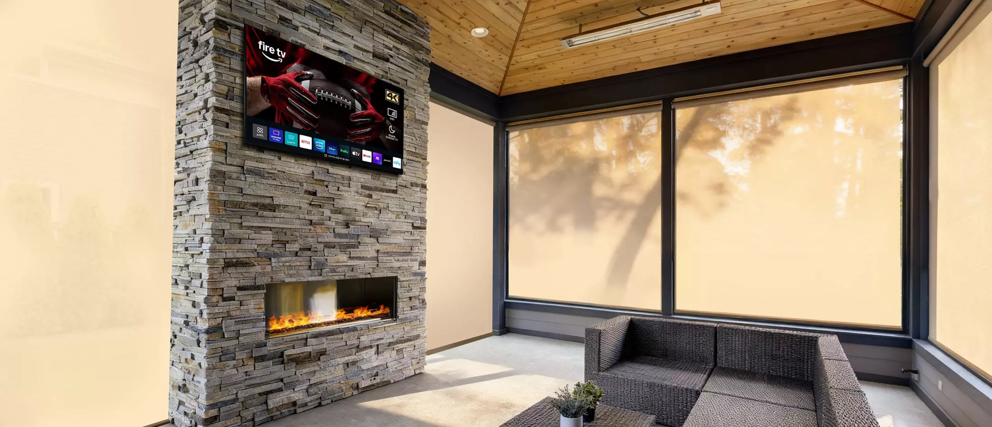 Modern living room with a stone fireplace and MirageVision Outdoor TV.