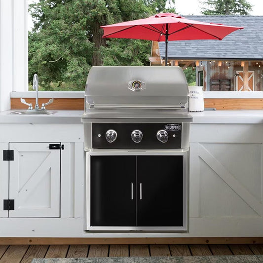 Outdoor kitchen with a stainless steel grill and red umbrella